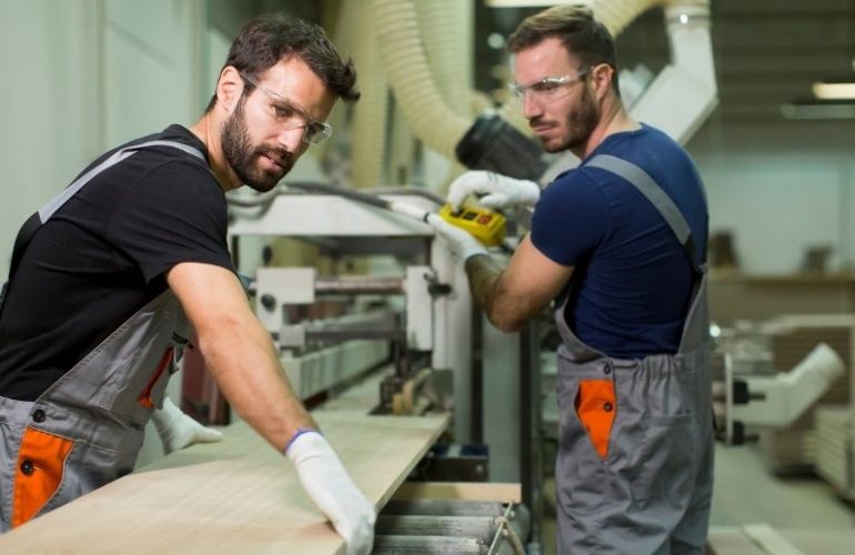 Mitarbeiter arbeiten gemeinsam in einem Produktionsumfeld im Rahmen der Arbeitnehmerüberlassung